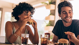 Man smiling while talking on phone