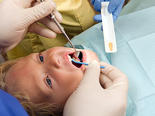 Young child receiving fluoride treatment