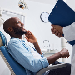 smiling patient talking to dentist at appointment