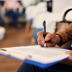 woman filling out dental insurance form in the lobby